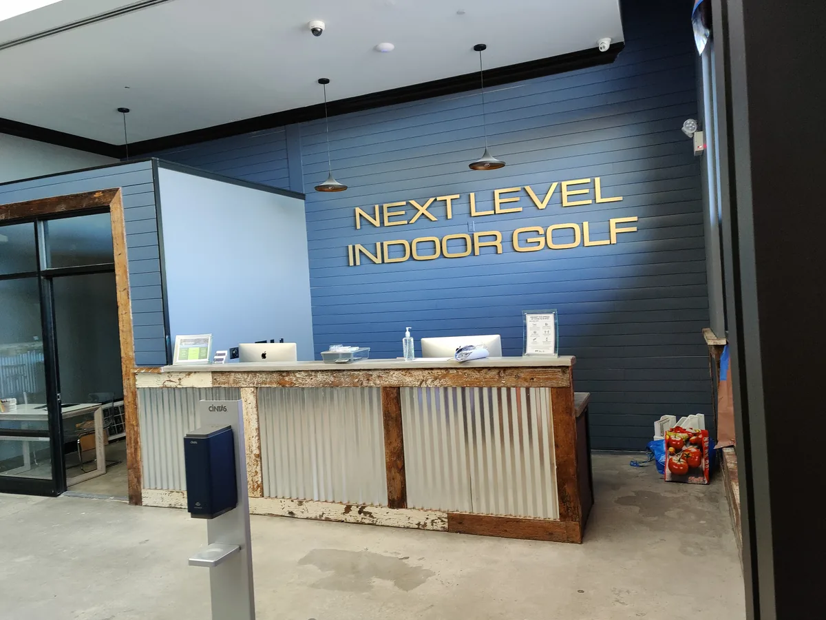 Commercial venue reception area with ceiling-mounted security cameras and access control system