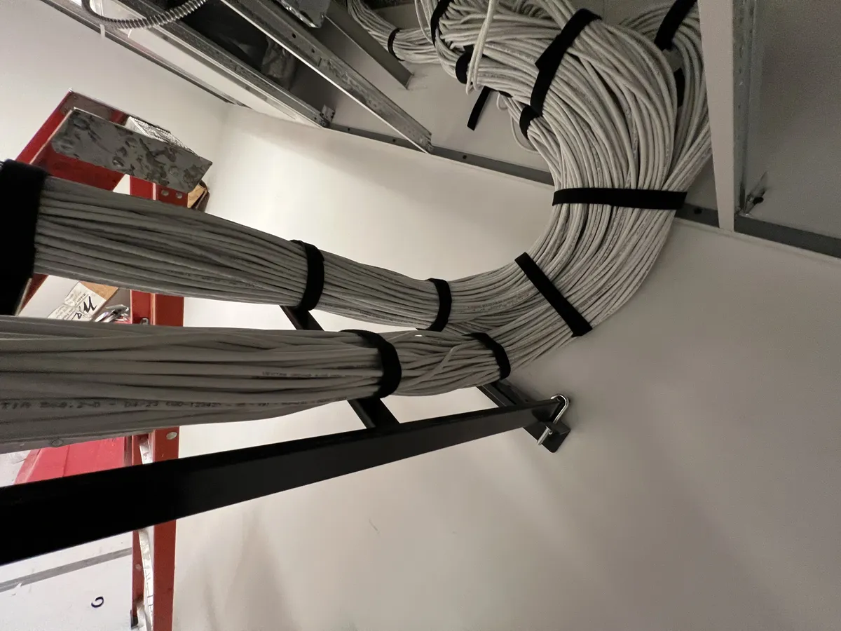 Close-up of cable service loop with velcro ties on ladder rack